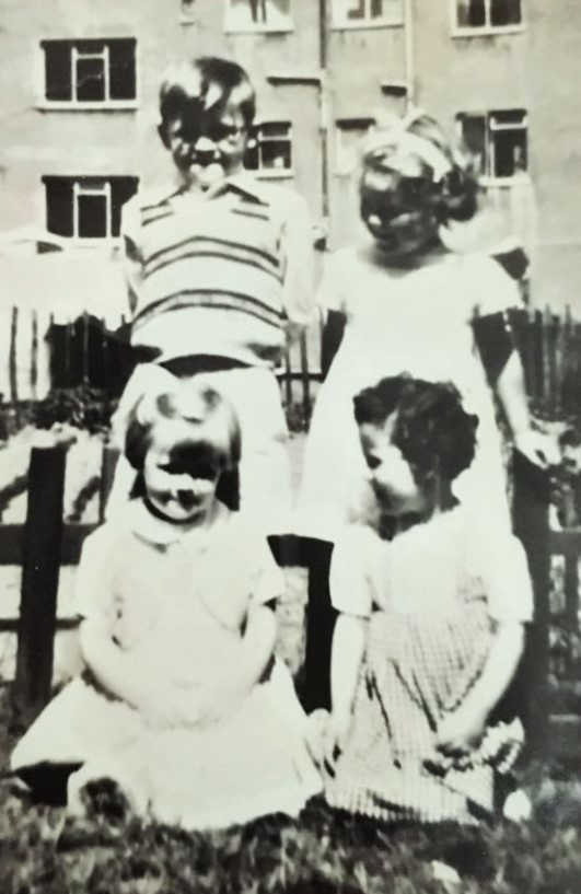 Mike Kelly With Sisters Evelyn And Marion, And Neighbours Elizabeth Bell Standing, And Jean Morton. 4 Barnkirk Avenue, Drumchapel, 1958. Courtesy Of Mike Kelly image