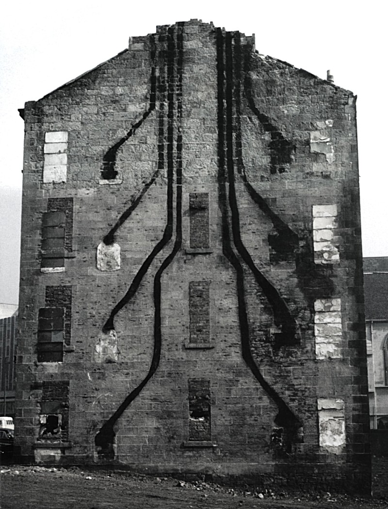 An Exposed Gable After The Demolition Of An Adjoining Tenement Looks Like A Soot Rendered Circuit Board Of Fire Places To Chimneys image